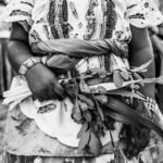 a woman in a dress holding a bunch of flowers